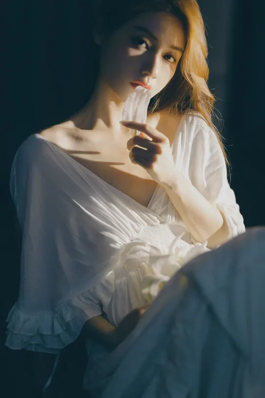 一位穿着白色连衣裙的年轻女子手拿香烟的肖像