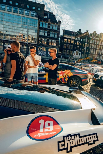 一些人在街上站在一辆汽车前面