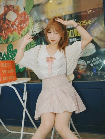 一位年轻女子在吹干头发时摆姿势