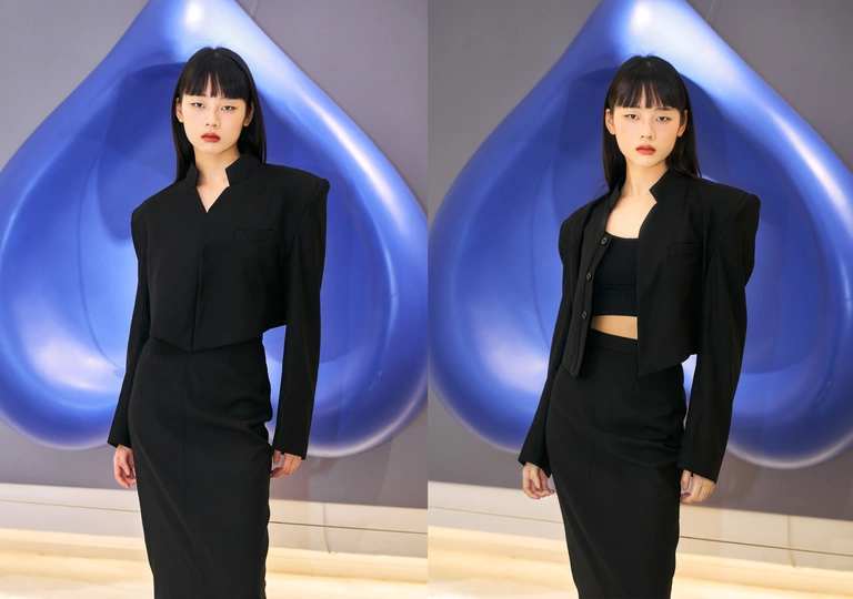 一个穿着黑色西装的模特站在时装秀的跑道上