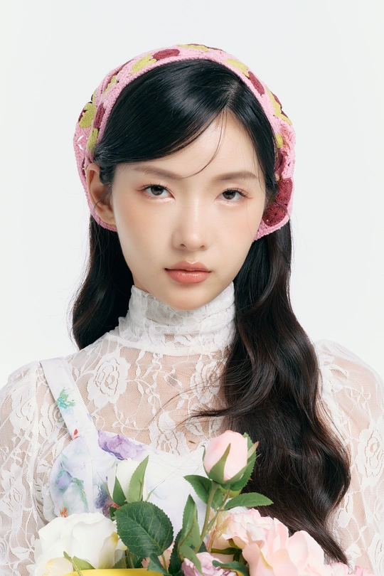 一位年轻女子穿着白色连衣裙 拿着粉色花束的肖像