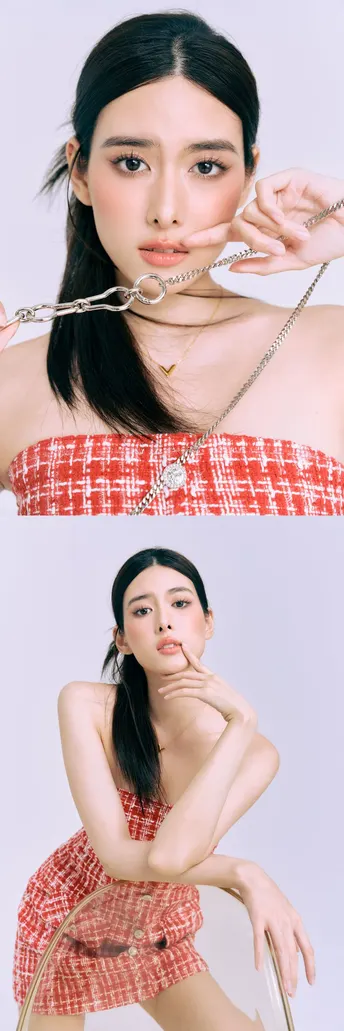 一位穿着红白相间裙子的女人戴着项链在脸上摆姿势