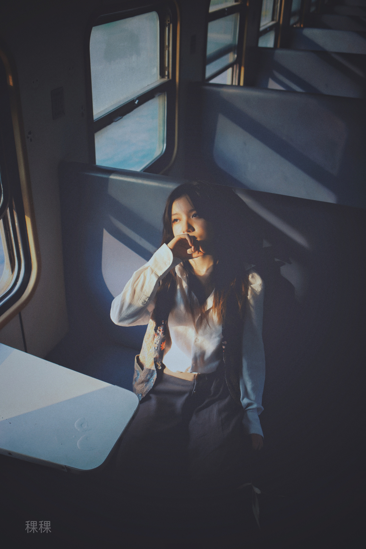 坐在火车上靠窗的年轻女子