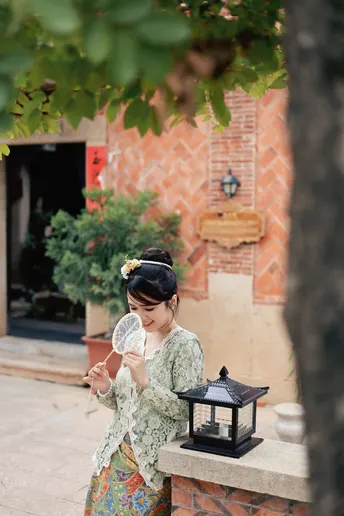 一位穿着和服的年轻女子手持灯笼走在街上。