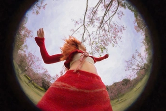 一张穿着红裙子的女人和背景中的树的照片