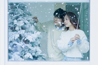雪树前站着一对夫妇的图片