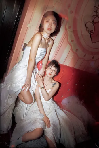 一些穿着白色连衣裙的年轻女性在为拍照摆姿势