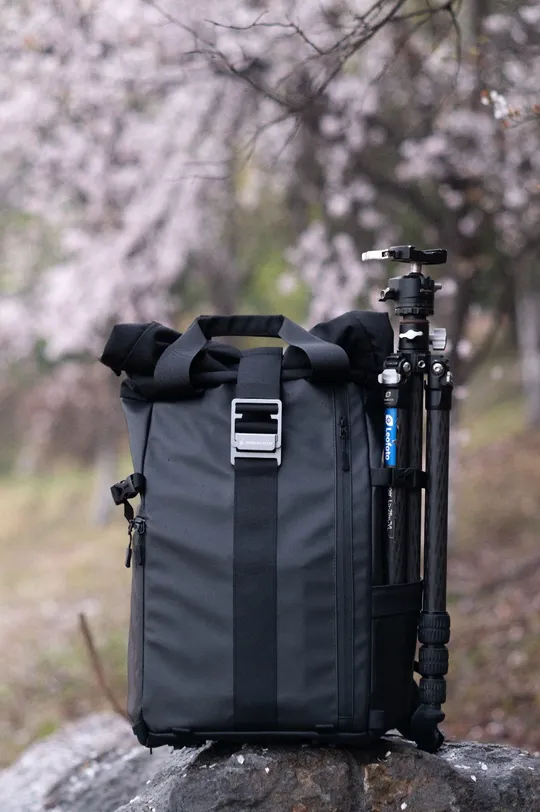 a black bag on a rock next to a bike