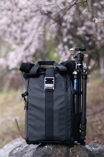 a black bag on a rock next to a bike