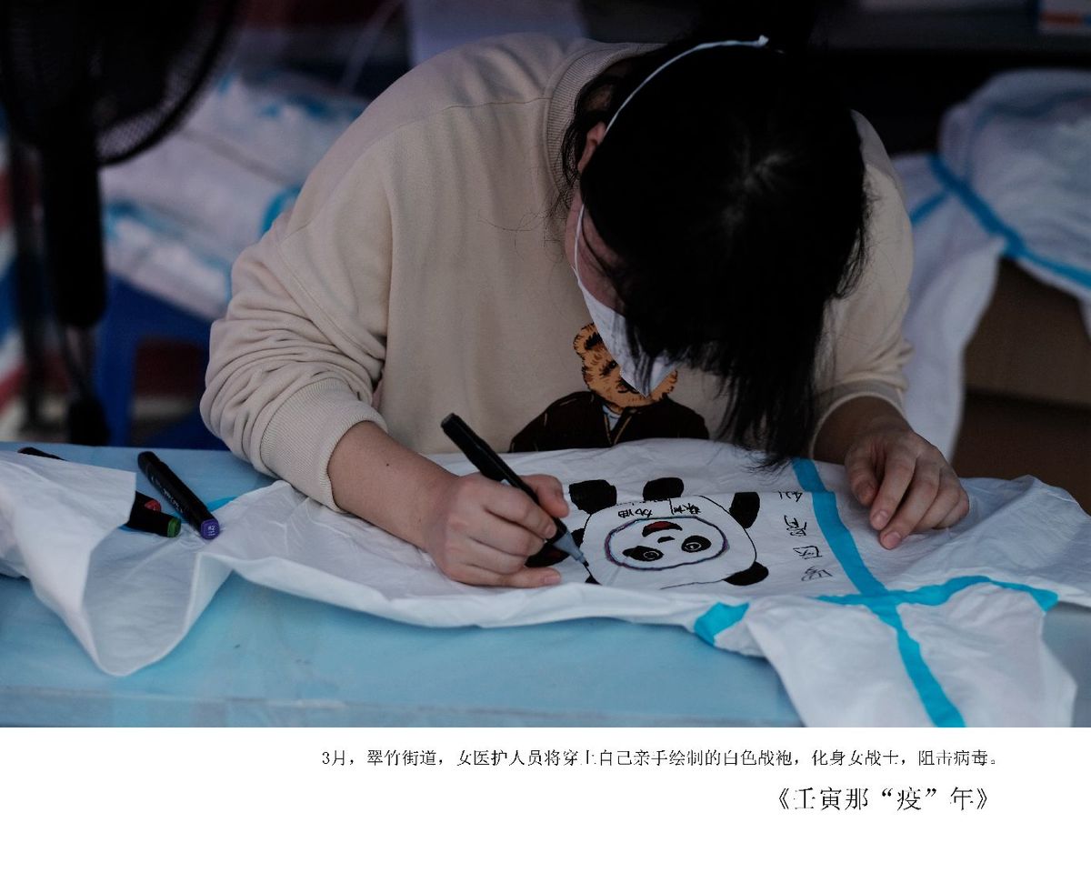 一个年轻女孩在桌子上用剪刀在一张纸上画设计。