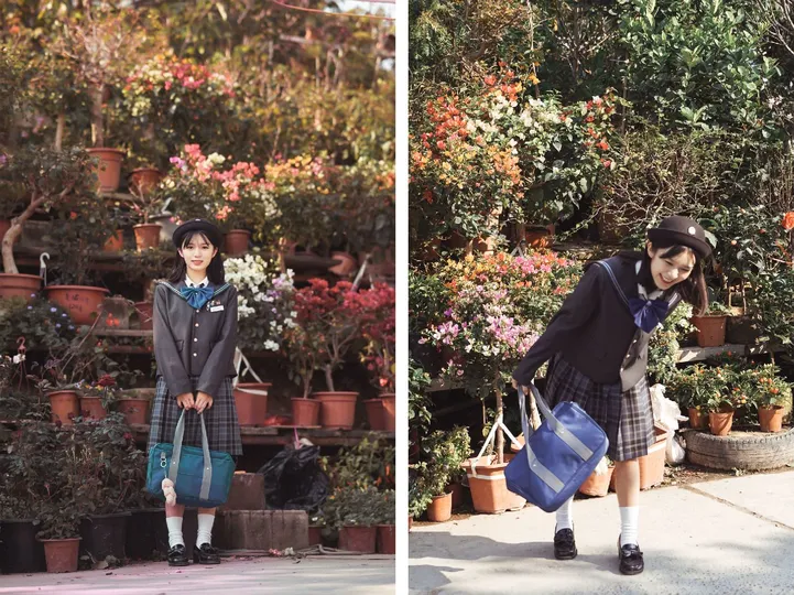 一位穿着校服的年轻女孩站在人行道上 手里拿着一个袋子 前面有一些植物和花。