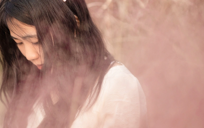 一位年轻女子 头发如云般飘在水中。