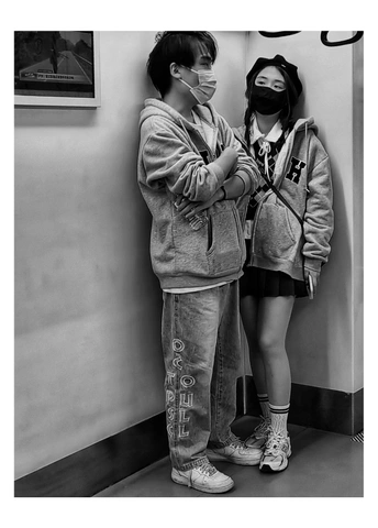 一张黑白照片 一个年轻男孩和一个年轻女孩都戴着面具。