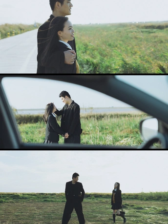 一个人和一个女人并排走在一条路上 手牵着手 注视着一辆在田地里行驶的车。