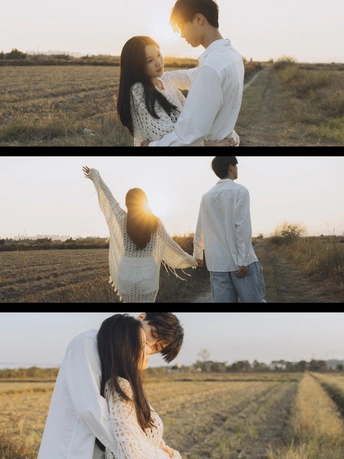 一个人和一个女人站在田野里 手拉手。