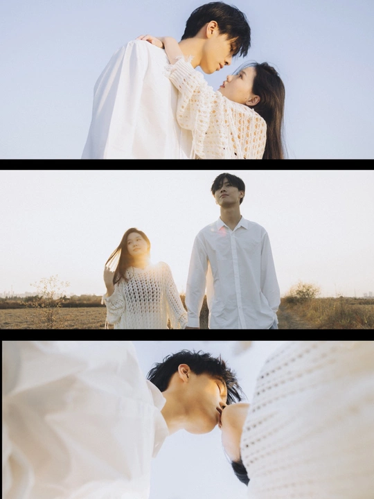 一个男人和一个女人站在一个田野里 背景是天空。