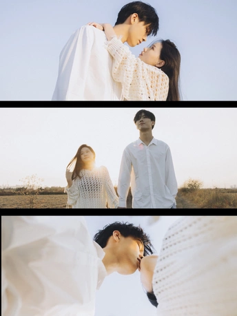 一个男人和一个女人站在一个田野里 背景是天空。