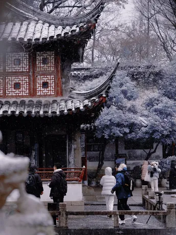 人们在冬天走过一座佛塔 地上铺满了雪。