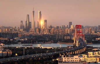 傍晚或日落时城市的天际线 高耸的建筑和横跨城市宽度的桥。