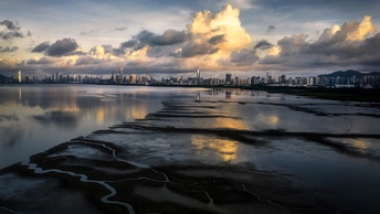 天空中有云的河流和远处的城市