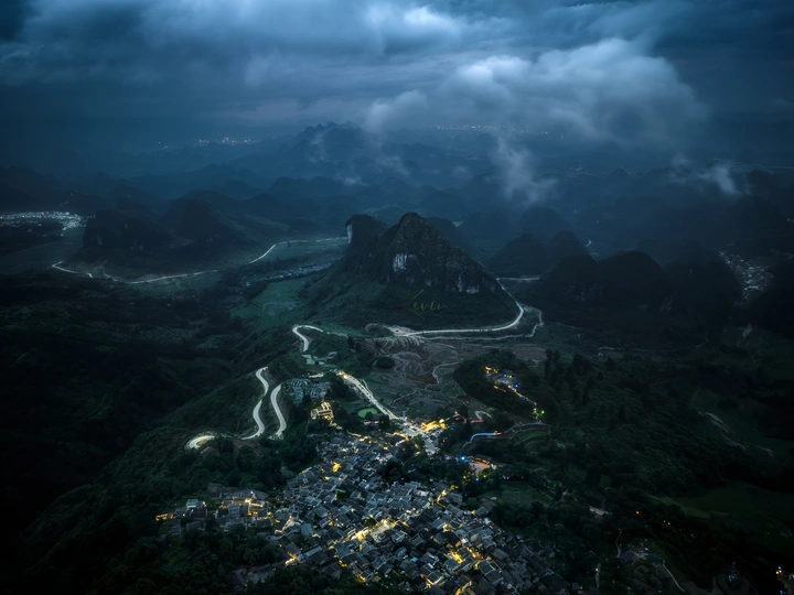 山谷中的城市夜晚 天空中云朵飘荡。