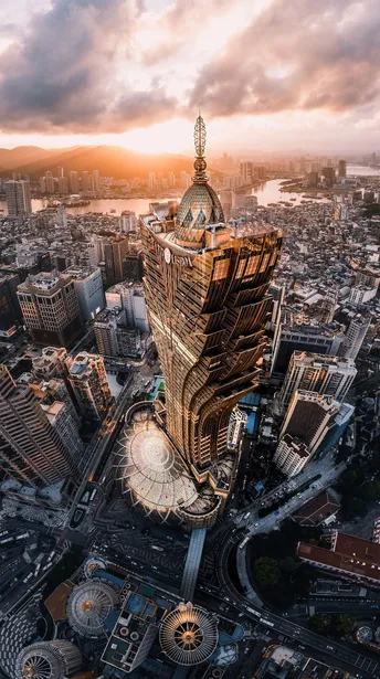 a photo of a city at sunset from the top of a tall