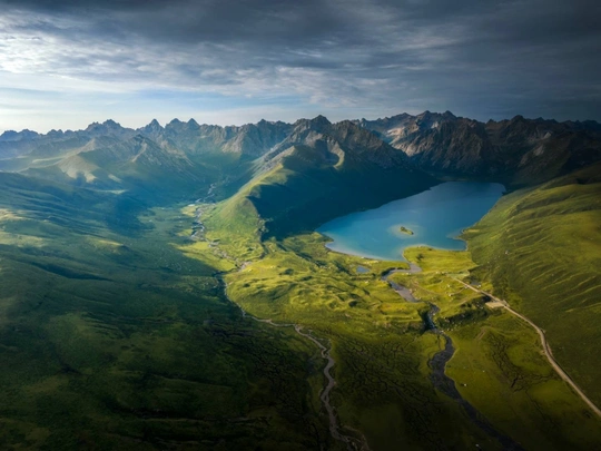 aerial view of a green valley and mountains