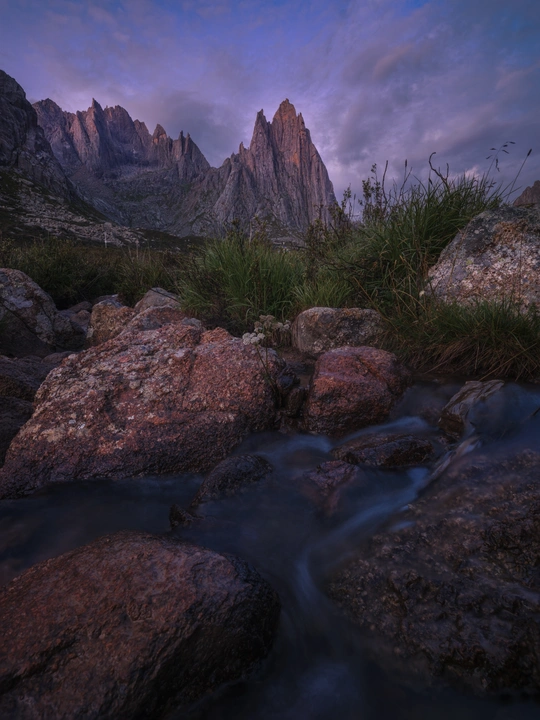 a small stream of water flowing over rocks with a 