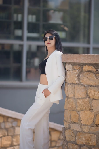 一位女士穿着黑色上衣和白色裤子