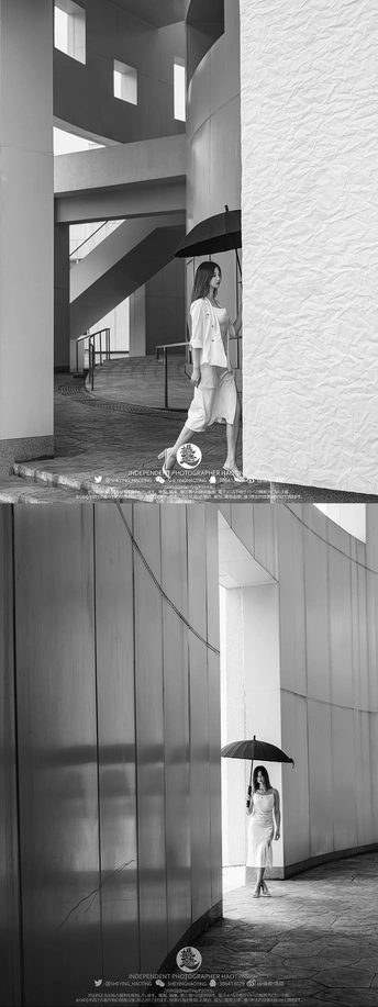 一张黑白照片 一位女士站在一座建筑物中 手里拿着一把伞。