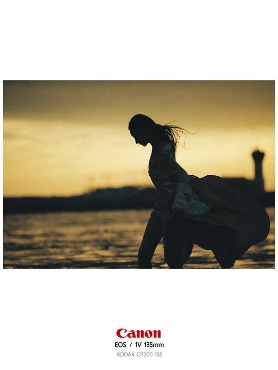 日落时 一个穿着连衣裙的年轻女孩在海滩上奔跑的剪影