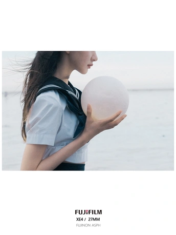 海滩上一个手里拿着球的年轻女子