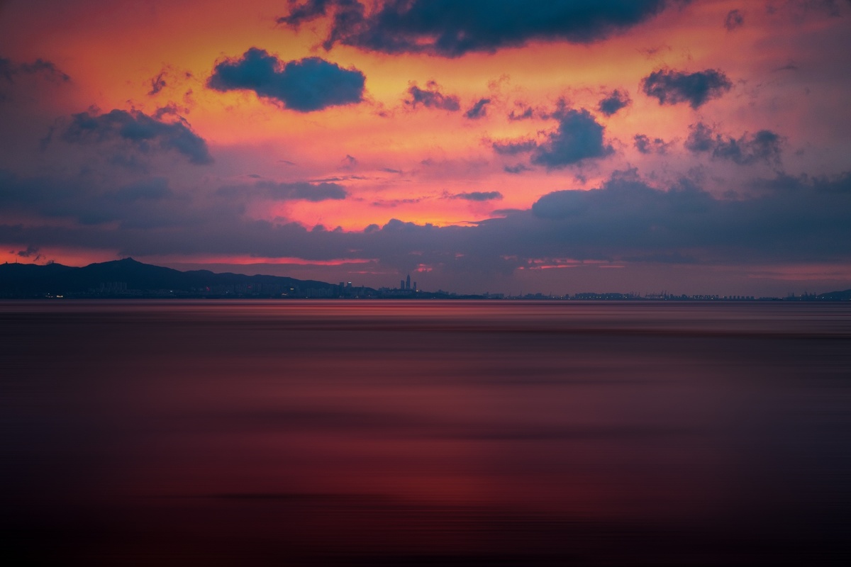 海洋上的日落 伴有紫色的云和红色的天空