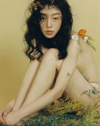 一个年轻女子坐在地上 头戴鲜花