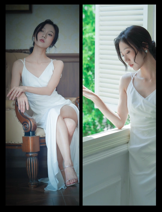 一个穿着白色连衣裙的女人坐在窗户旁边