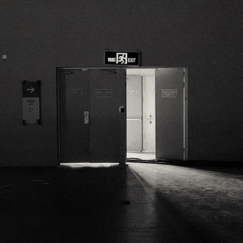 一个黑暗的房间 门是敞开的 墙上挂着一张告示。