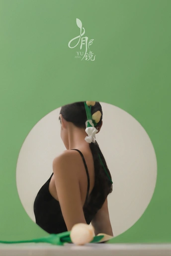 一个穿黑色衣服的女孩坐在花丛中