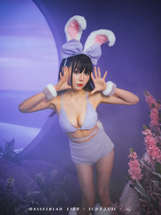 一位女士正在给兔子拍照