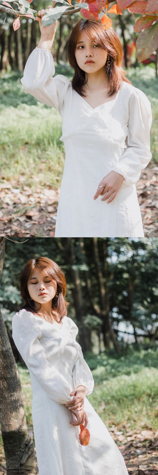 一个穿着白衬衫的年轻女子拿着一片树叶在树林里摆姿势拍照