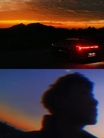 日落时一辆车上的一个男人和一个红灯