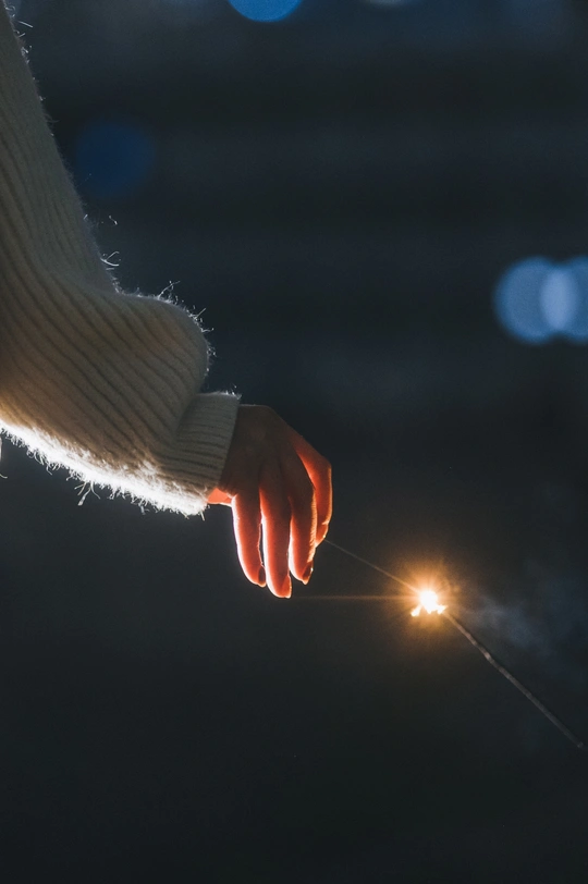 一个人在晚上拿着点燃的火花