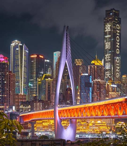 夜晚的城市 天际线被点亮 前景是一座桥。