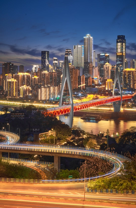 夜晚的城市 有大型天际线和横跨河流的桥。