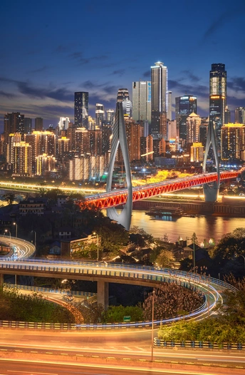 夜晚的城市 有大型天际线和横跨河流的桥。