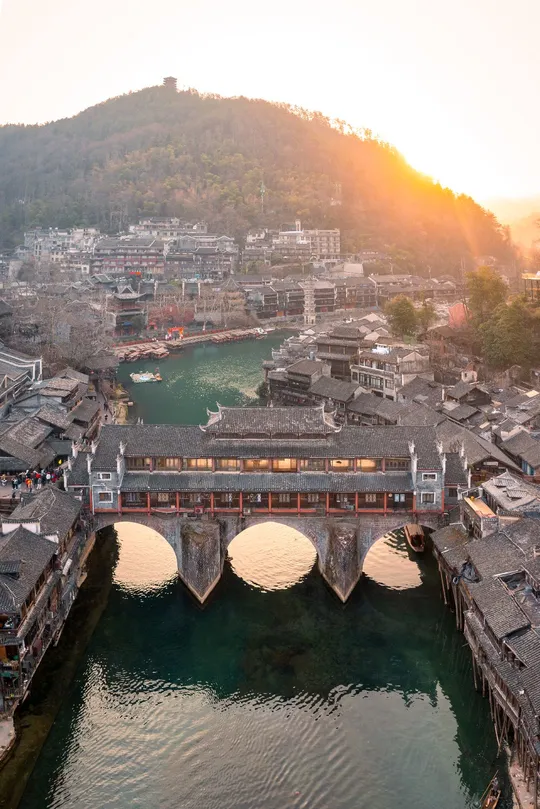 一条大河上有建筑物和一座桥。