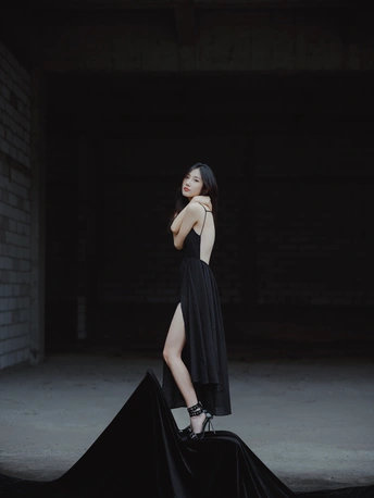 一位穿着黑色连衣裙带有拖尾的年轻女子