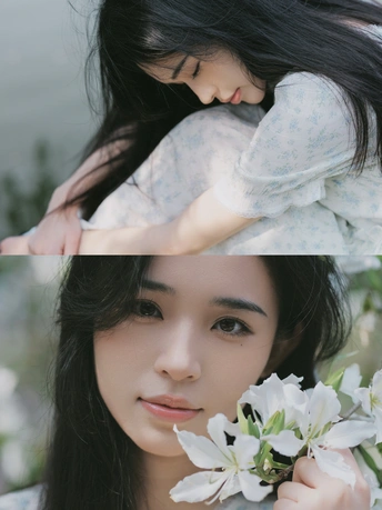 一位美丽的女子抱着白色的花在她面前