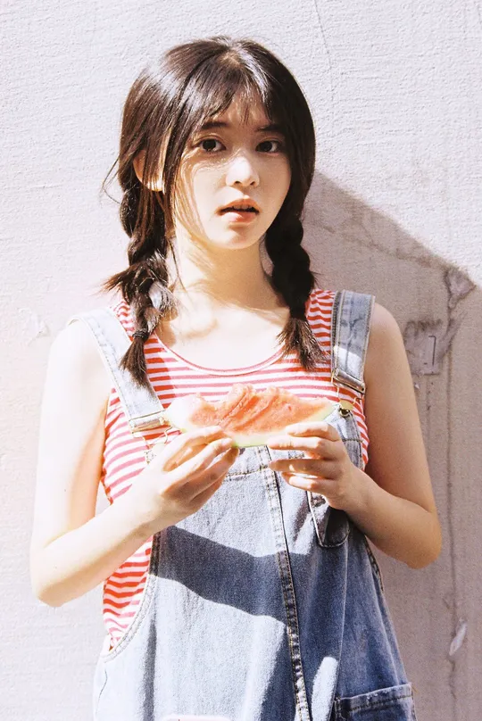 一个穿着工作服的小女孩手里拿着东西