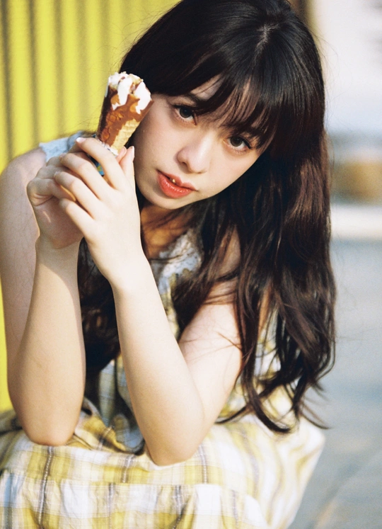 一位年轻女子手里拿着食物坐着