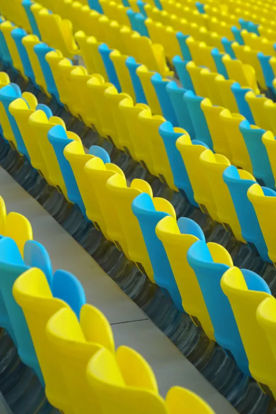 蓝色和黄色的带有塑料桌椅的体育场